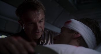 Movie still from “Jurassic Park III” (2001), directed by Joe Johnston – A man with bandages on his head is looking at another man with bandages on his head; Close Up shot, Low angle
