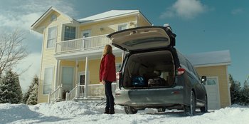 Movie still from “Jurassic World” (2015), directed by Colin Trevorrow – A woman standing next to a car in the snow; Wide shot, Low angle