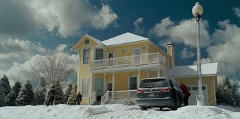 Movie still from “Jurassic World” (2015), directed by Colin Trevorrow – A car is parked in front of a yellow house; Extreme Wide shot, Low angle