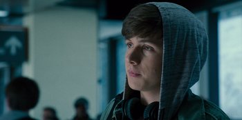 Movie still from “Jurassic World” (2015), directed by Colin Trevorrow – A young man wearing headphones and a hooded sweatshirt; Close Up shot, Over the shoulder angle