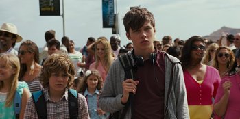 Movie still from “Jurassic World” (2015), directed by Colin Trevorrow – A group of people walking down a street; Medium shot, Low angle