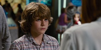 Movie still from “Jurassic World” (2015), directed by Colin Trevorrow – A young boy is looking into the distance; Close Up shot, Over the shoulder angle