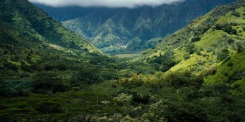 Movie still from “Jurassic World” (2015), directed by Colin Trevorrow – A view of a lush green mountain valley; Extreme Wide shot, High angle