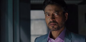 Movie still from “Jurassic World” (2015), directed by Colin Trevorrow – A person wearing a suit and tie; Close Up shot, Over the shoulder angle