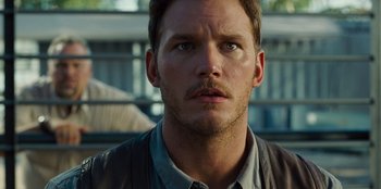 Movie still from “Jurassic World” (2015), directed by Colin Trevorrow – A person with a mustache; Close Up shot, Over the shoulder angle