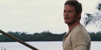 Movie still from “Jurassic World” (2015), directed by Colin Trevorrow – A person with a boat in the background; Close Up shot, Over the shoulder angle