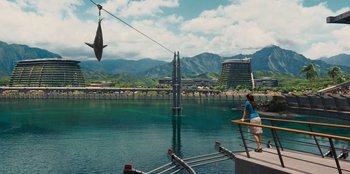 Movie still from “Jurassic World” (2015), directed by Colin Trevorrow – A woman standing next to a body of water; Extreme Wide shot, High angle