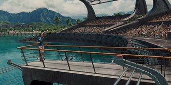 Movie still from “Jurassic World” (2015), directed by Colin Trevorrow – A person standing on a platform near a pool; Extreme Wide shot, High angle
