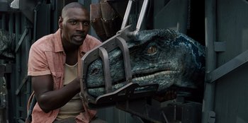 Movie still from “Jurassic World” (2015), directed by Colin Trevorrow – A man is holding a dinosaur head in his hands; Close Up shot, Low angle