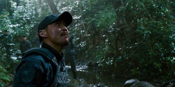 Movie still from “Jurassic World” (2015), directed by Colin Trevorrow – A man standing next to a river in a forest; Close Up shot, Over the shoulder angle