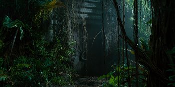 Movie still from “Jurassic World” (2015), directed by Colin Trevorrow – A dark forest with vines growing all over it; Extreme Wide shot, High angle