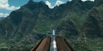 Movie still from “Jurassic World” (2015), directed by Colin Trevorrow – An image of a train going down the tracks in the mountains; Extreme Wide shot, High angle
