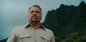 Movie still from “Jurassic World” (2015), directed by Colin Trevorrow – A person wearing a shirt; Close Up shot, Low angle