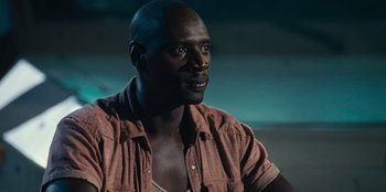 Movie still from “Jurassic World” (2015), directed by Colin Trevorrow – A person sitting in a room; Close Up shot, Over the shoulder angle