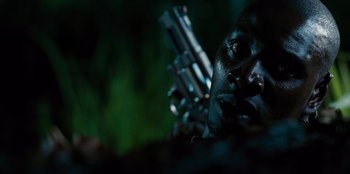 Movie still from “Jurassic World” (2015), directed by Colin Trevorrow – A man's face with guns in the background; Close Up shot, Low angle