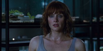 Movie still from “Jurassic World” (2015), directed by Colin Trevorrow – A person wearing a tank top; Close Up shot, Over the shoulder angle