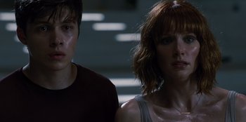 Movie still from “Jurassic World” (2015), directed by Colin Trevorrow – A woman and a man standing next to each other; Close Up shot, Low angle