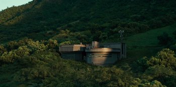 Movie still from “Jurassic World” (2015), directed by Colin Trevorrow – An aerial view of a building on top of a hill; Extreme Wide shot, High angle