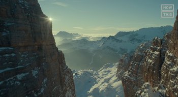 Movie still from “Jurassic World Dominion” (2022), directed by Colin Trevorrow – The sun is shining over the mountains in the winter time; Extreme Wide shot, Low angle
