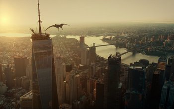 Movie still from “Jurassic World Dominion” (2022), directed by Colin Trevorrow – An aerial view of a city with a bird flying over it; Extreme Wide shot, Low angle