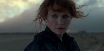 Movie still from “Jurassic World Dominion” (2022), directed by Colin Trevorrow – A person wearing a black jacket; Close Up shot, Low angle