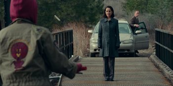 Movie still from “Jurassic World Dominion” (2022), directed by Colin Trevorrow – A woman standing on the side of a road near a car; Wide shot, Over the shoulder angle