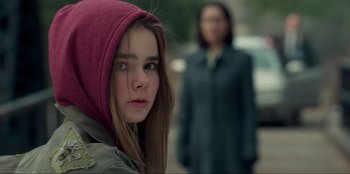 Movie still from “Jurassic World Dominion” (2022), directed by Colin Trevorrow – A young girl wearing a pink hooded jacket; Close Up shot, Over the shoulder angle