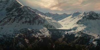 Movie still from “Jurassic World Dominion” (2022), directed by Colin Trevorrow – A view of a mountain range with snow on it's slopes; Extreme Wide shot, High angle