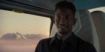 Movie still from “Jurassic World Dominion” (2022), directed by Colin Trevorrow – A man sitting in a car looking out the window; Close Up shot, Over the shoulder angle