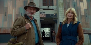 Movie still from “Jurassic World Dominion” (2022), directed by Colin Trevorrow – A man and a woman standing next to each other; Medium shot, Low angle