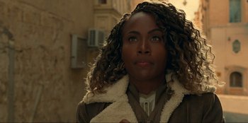 Movie still from “Jurassic World Dominion” (2022), directed by Colin Trevorrow – A person wearing a jacket; Close Up shot, Over the shoulder angle