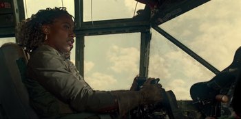 Movie still from “Jurassic World Dominion” (2022), directed by Colin Trevorrow – A person sitting in the cockpit of an airplane; Medium shot, Low angle
