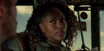 Movie still from “Jurassic World Dominion” (2022), directed by Colin Trevorrow – A person wearing a jacket; Close Up shot, Over the shoulder angle