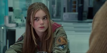 Movie still from “Jurassic World Dominion” (2022), directed by Colin Trevorrow – A young girl with long hair is sitting in a room; Close Up shot, Over the shoulder angle