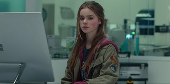 Movie still from “Jurassic World Dominion” (2022), directed by Colin Trevorrow – A young girl sitting in front of a computer monitor; Medium shot, Over the shoulder angle