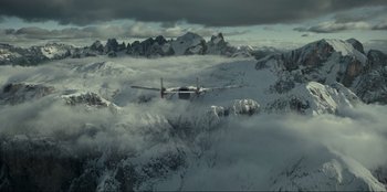 Movie still from “Jurassic World Dominion” (2022), directed by Colin Trevorrow – An airplane is flying over a snowy mountain; Extreme Wide shot, High angle