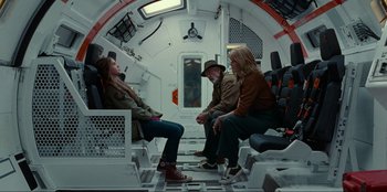 Movie still from “Jurassic World Dominion” (2022), directed by Colin Trevorrow – A group of people sitting in a space ship; Wide shot, High angle