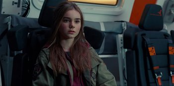 Movie still from “Jurassic World Dominion” (2022), directed by Colin Trevorrow – A young woman sitting on a train looking into the distance; Close Up shot, High angle