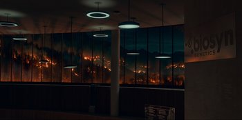 Movie still from “Jurassic World Dominion” (2022), directed by Colin Trevorrow – A view of a city at night through a large window; Extreme Wide shot, High angle