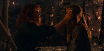 Movie still from “Jurassic World Dominion” (2022), directed by Colin Trevorrow – A woman putting makeup on another woman's face; Close Up shot, Over the shoulder angle