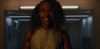 Movie still from “Jurassic World Dominion” (2022), directed by Colin Trevorrow – A person with curly hair smiling; Close Up shot, Over the shoulder angle