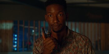 Movie still from “Jurassic World Dominion” (2022), directed by Colin Trevorrow – A person holding a cell phone; Close Up shot, Over the shoulder angle