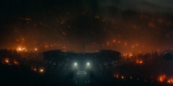 Movie still from “Jurassic World Dominion” (2022), directed by Colin Trevorrow – A group of people standing in front of a fire; Extreme Wide shot, High angle