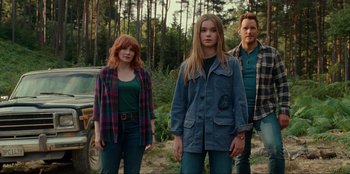Movie still from “Jurassic World Dominion” (2022), directed by Colin Trevorrow – Two women and a man standing next to each other in the woods; Medium shot, Low angle