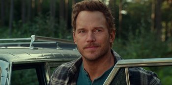 Movie still from “Jurassic World Dominion” (2022), directed by Colin Trevorrow – A person wearing a plaid shirt; Close Up shot, Over the shoulder angle