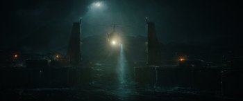 Movie still from “Jurassic World: Fallen Kingdom” (2018), directed by J.A. Bayona – A helicopter flying over a body of water at night; Extreme Wide shot, Low angle
