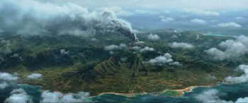 Movie still from “Jurassic World: Fallen Kingdom” (2018), directed by J.A. Bayona – An aerial view of a volcano spewing smoke and clouds; Extreme Wide shot, High angle