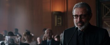 Movie still from “Jurassic World: Fallen Kingdom” (2018), directed by J.A. Bayona – A man standing in front of a group of people; Close Up shot, Over the shoulder angle
