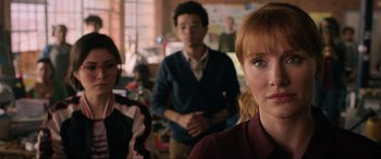 Movie still from “Jurassic World: Fallen Kingdom” (2018), directed by J.A. Bayona – A group of people standing in a room; Close Up shot, Over the shoulder angle