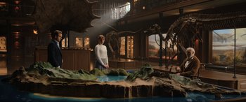 Movie still from “Jurassic World: Fallen Kingdom” (2018), directed by J.A. Bayona – A woman standing in front of a dinosaur display in a room; Wide shot, Low angle